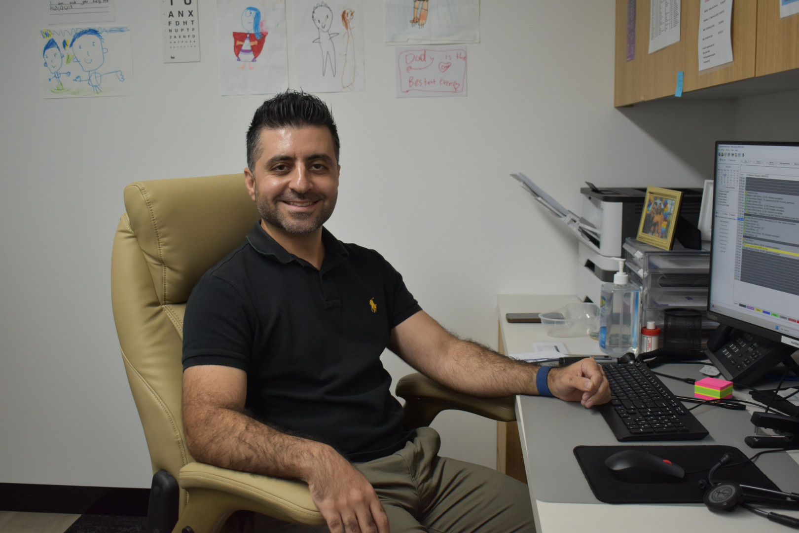 Dr Payim Faraid sitting at his desk at Terry Street Medical.