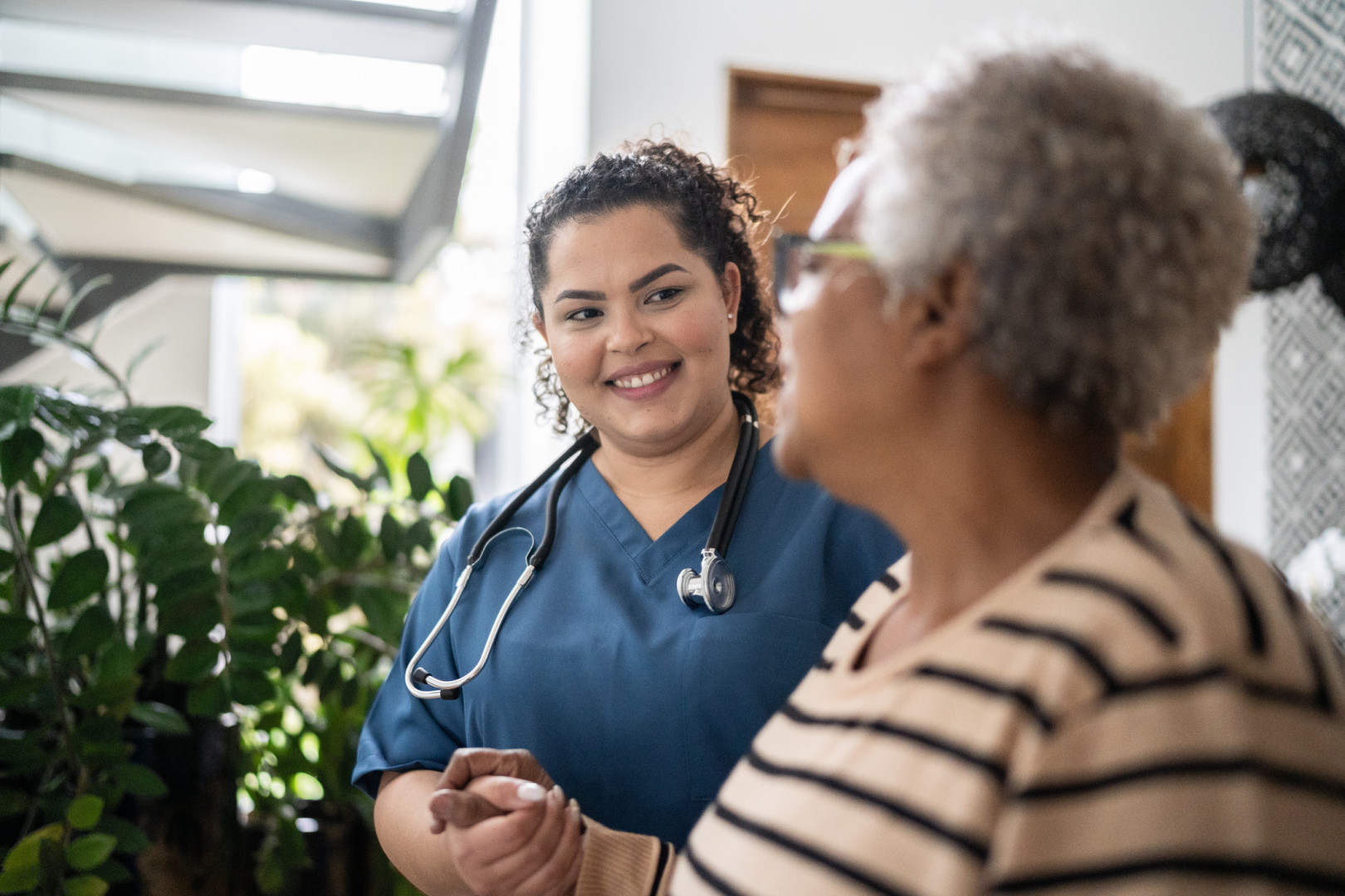 Aboriginal Health care worker supporting elderly aboriginal patient