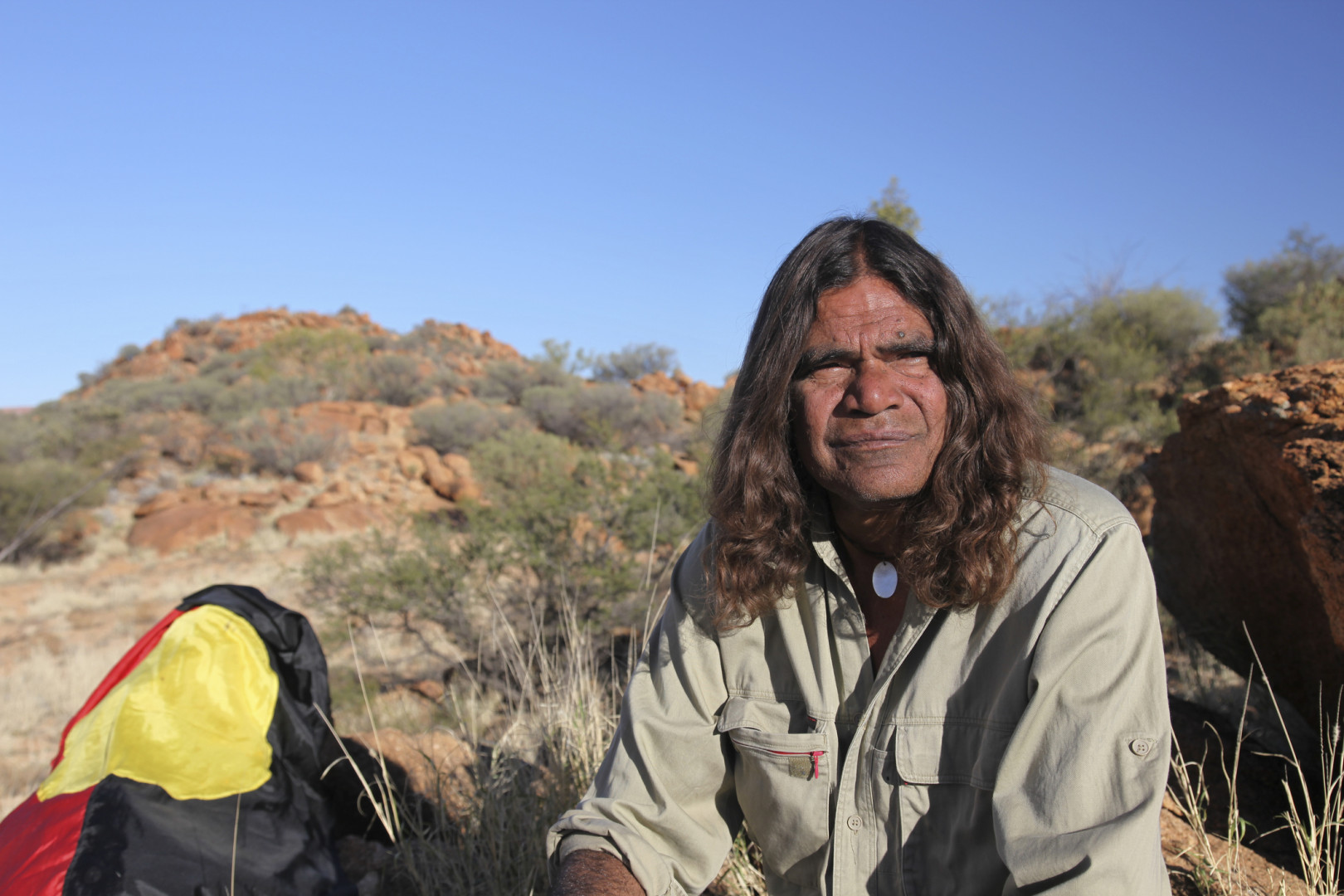 Aboriginal elder woman wearing a bright pink shirt 