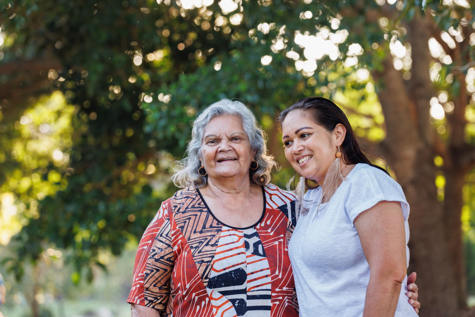 Elderly Aboriginal women smiling for a photo with a younger Aboriginal women