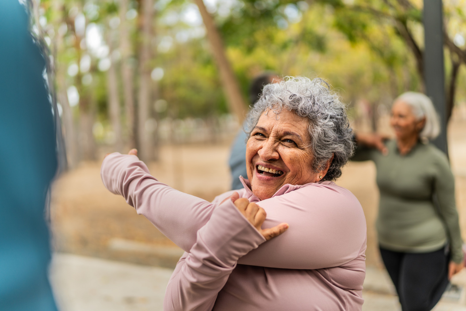 Older person stretching outside before going for a run.